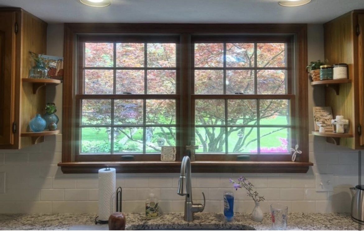 Fairborn kitchen window before replacement, with old gridded double-hungs